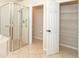 Bathroom with shower, linen closet, and shelving at 12650 Montigello Ct, Englewood, FL 34223