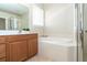 Bathroom with vanity, garden tub, and shower at 12650 Montigello Ct, Englewood, FL 34223