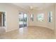 Bright bedroom with tile floors, sliding door to patio, and pool view at 12650 Montigello Ct, Englewood, FL 34223