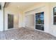 Spacious covered patio with brick pavers and sliding glass doors at 12650 Montigello Ct, Englewood, FL 34223