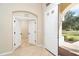 Bright entryway with view of backyard, tile flooring and access to other rooms at 12650 Montigello Ct, Englewood, FL 34223