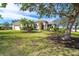 Single-story house with a large tree and manicured lawn at 12650 Montigello Ct, Englewood, FL 34223