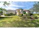 Single-story house with lush landscaping and a palm tree at 12650 Montigello Ct, Englewood, FL 34223