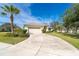 Single story house with attached garage and palm trees at 12650 Montigello Ct, Englewood, FL 34223