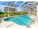 Enjoy this refreshing kidney shaped pool with a screened enclosure at 12650 Montigello Ct, Englewood, FL 34223