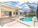 Inviting kidney-shaped pool with a screened enclosure at 12650 Montigello Ct, Englewood, FL 34223