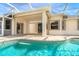 Resort style pool with covered patio and screened enclosure at 12650 Montigello Ct, Englewood, FL 34223