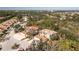 Aerial view of two-story condos with tile roofs, surrounded by lush landscaping at 129 Preserve Pl # A, Nokomis, FL 34275