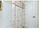 Simple bathroom with a tub and floral shower curtain at 129 Preserve Pl # A, Nokomis, FL 34275