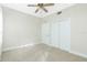 Bright bedroom with ceiling fan and double door closet at 129 Preserve Pl # A, Nokomis, FL 34275