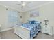 Serene bedroom with a queen-size bed, nightstand, and ceiling fan at 129 Preserve Pl # A, Nokomis, FL 34275