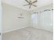 Spacious bedroom with neutral carpeting and two windows at 129 Preserve Pl # A, Nokomis, FL 34275