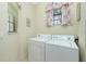 Bright laundry room with washer, dryer, and window at 129 Preserve Pl # A, Nokomis, FL 34275