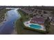 Aerial view of community with pool, clubhouse, and lake at 13489 Abercrombie Dr, Englewood, FL 34223