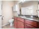 Bathroom with granite countertop and a cabinet at 13489 Abercrombie Dr, Englewood, FL 34223