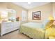 Guest bedroom with white dresser and floral bedding at 13489 Abercrombie Dr, Englewood, FL 34223