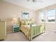 Charming bedroom with light green wooden bed frame and water view at 13489 Abercrombie Dr, Englewood, FL 34223