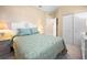 Bright bedroom with floral bedding and built-in closet at 13489 Abercrombie Dr, Englewood, FL 34223