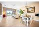 Bright dining area with table and chairs, view to living room and water at 13489 Abercrombie Dr, Englewood, FL 34223