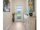 Bright entryway with decorative console table and artwork at 13489 Abercrombie Dr, Englewood, FL 34223