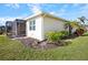 Home exterior showcasing a screened patio and lush landscaping at 13489 Abercrombie Dr, Englewood, FL 34223