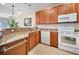 Modern kitchen with wood cabinets and granite countertops at 13489 Abercrombie Dr, Englewood, FL 34223