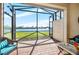 Spacious screened lanai with lake view and patio furniture at 13489 Abercrombie Dr, Englewood, FL 34223