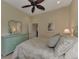 Guest bedroom with light green dresser and ceiling fan at 13760 Long Lake Ln, Port Charlotte, FL 33953