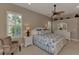 Primary bedroom with white furniture and a ceiling fan at 13760 Long Lake Ln, Port Charlotte, FL 33953