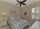 Spacious bedroom with blue bedding and plantation shutters at 13760 Long Lake Ln, Port Charlotte, FL 33953