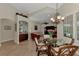 Casual dining area with a glass top table and chairs, near kitchen at 13760 Long Lake Ln, Port Charlotte, FL 33953