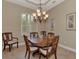 Elegant dining room with a wood table and chandelier at 13760 Long Lake Ln, Port Charlotte, FL 33953