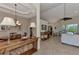 Dining room with a wooden table, chairs, and a view into the living room at 13760 Long Lake Ln, Port Charlotte, FL 33953