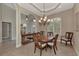 Formal dining room featuring a wood table and chandelier, and window with shutters at 13760 Long Lake Ln, Port Charlotte, FL 33953