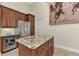 Island kitchen with granite countertops and stainless steel appliances at 13760 Long Lake Ln, Port Charlotte, FL 33953