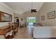 Living room with a large sectional sofa, tiled floors, and access to the pool area at 13760 Long Lake Ln, Port Charlotte, FL 33953