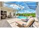 Relaxing pool area with covered patio and lounge chairs at 13760 Long Lake Ln, Port Charlotte, FL 33953