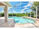 Inviting pool and spa with screened enclosure at 13760 Long Lake Ln, Port Charlotte, FL 33953