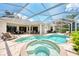 Resort-style pool and spa with outdoor seating at 13760 Long Lake Ln, Port Charlotte, FL 33953