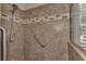 Walk-in shower with tiled walls and a grab bar at 13760 Long Lake Ln, Port Charlotte, FL 33953