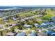 Aerial view of a house in a neighborhood near a golf course and waterway at 142 Caddy Rd, Rotonda West, FL 33947