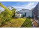 Private backyard with lush landscaping and shed at 142 Caddy Rd, Rotonda West, FL 33947