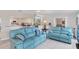 Comfortable living room with blue reclining sofas at 142 Caddy Rd, Rotonda West, FL 33947