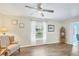 Bright living room with wood floors, window, and comfy chair at 142 Caddy Rd, Rotonda West, FL 33947