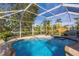 Relaxing screened pool with hammock and tiki bar at 142 Caddy Rd, Rotonda West, FL 33947