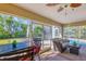 Relaxing screened porch with seating and pool view at 142 Caddy Rd, Rotonda West, FL 33947