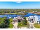 Aerial view of waterfront homes with lush landscaping and a canal at 14201 Joggins Ave, Port Charlotte, FL 33981