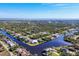 Wide aerial showcasing the neighborhood and waterfront location at 14201 Joggins Ave, Port Charlotte, FL 33981