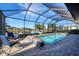 Relaxing pool area with covered patio and lounge chairs at 14201 Joggins Ave, Port Charlotte, FL 33981