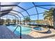 Enclosed pool and spa with covered patio overlooking a canal at 14201 Joggins Ave, Port Charlotte, FL 33981